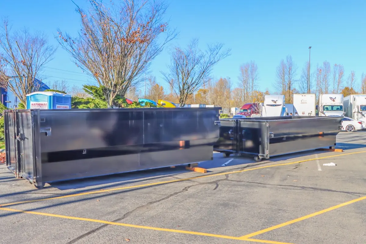 Professional dumpster rental service with roll-off container on residential driveway in Elmwood Park